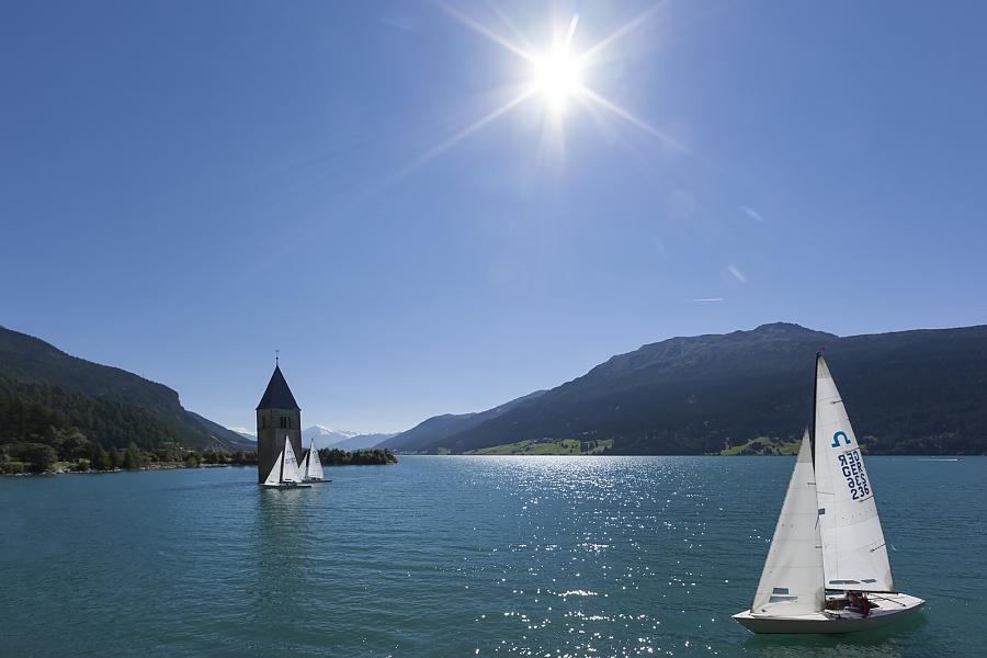 Sailing under the sun at Reschensee